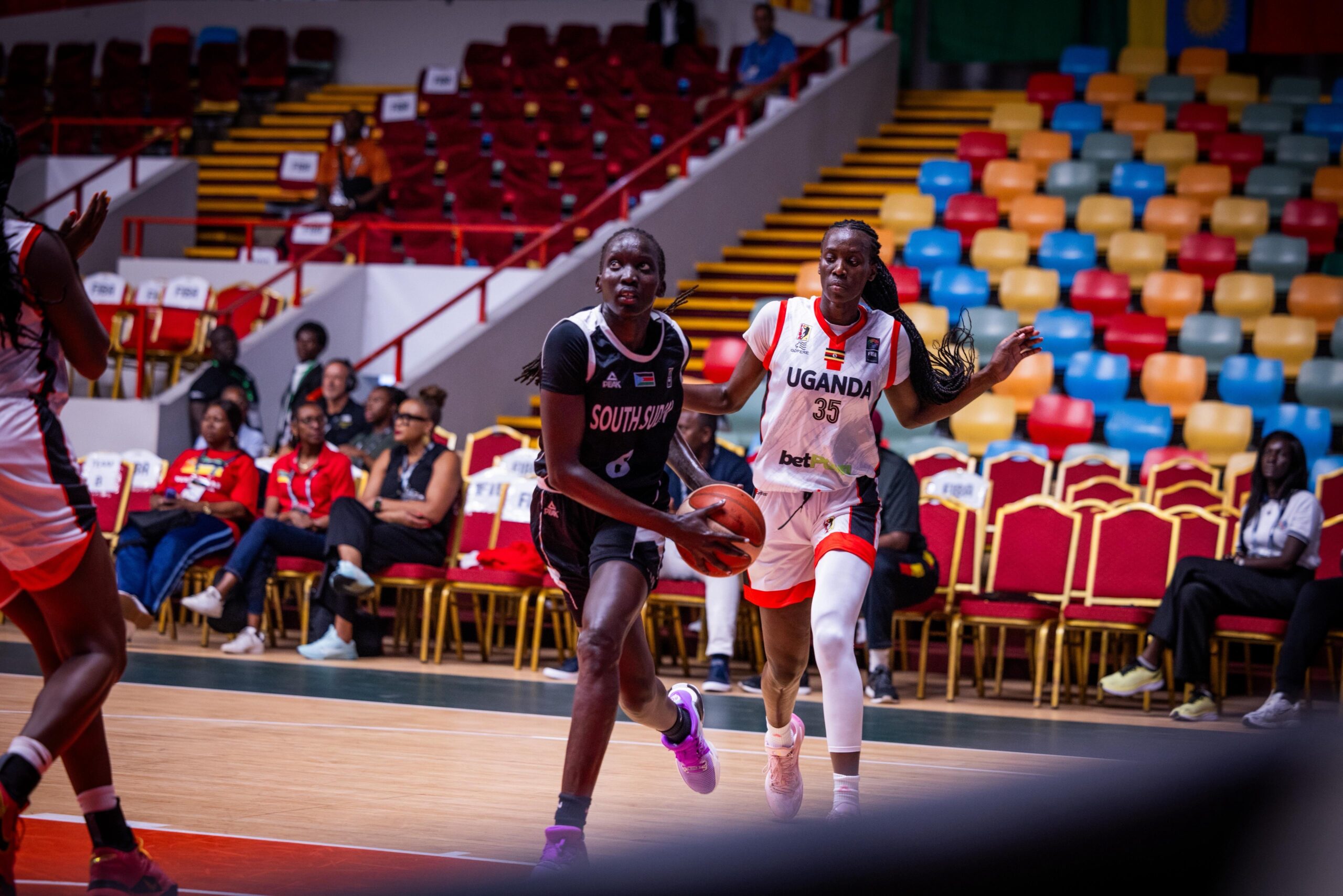 Rose passing Jane Asinde for a lay up